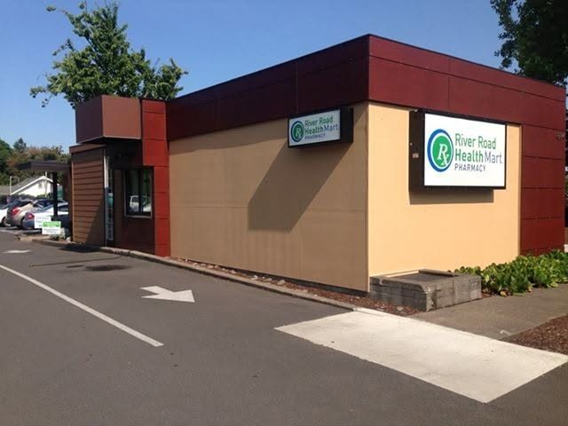 The River Road Pharmacy building on 884 River Road, its sign facing the parking lot